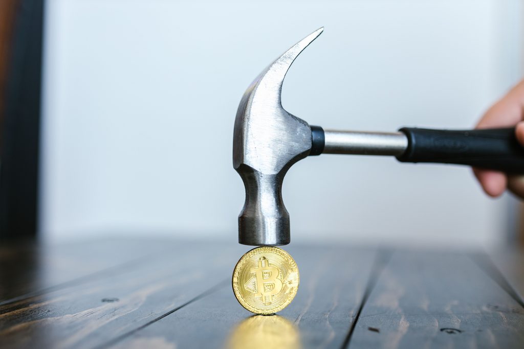 Bitcoin under a hammer representing P2P crypto exchange risks