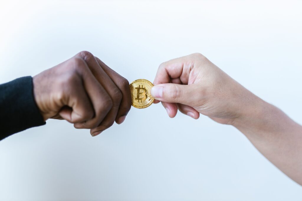 two hands exchanging crypto coin representing P2P trading
