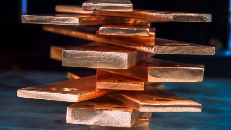 Copper bars stacked in a pile, representing Copper Price, Copper Futures, Copper Supply, Copper Shortage, and rising Copper Demand.