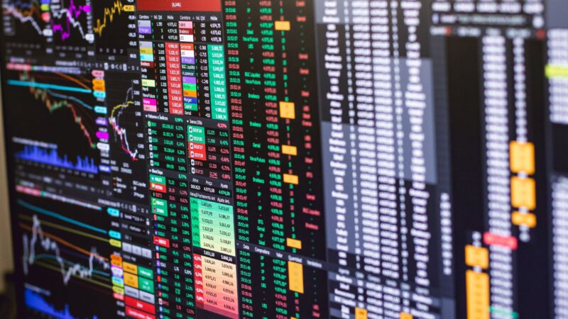 AI stocks and Global markets displayed on trading screens with charts and financial data, highlighting the Dot Com Bubble, Bond yields, and AI Valuations