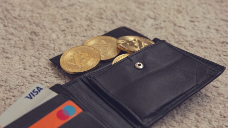 Bitcoin wallet with BTC coins and payment cards representing Trump crypto investments, Trump Coinbase, Strategy, Bitcoin price, and Bitcoin wallets.