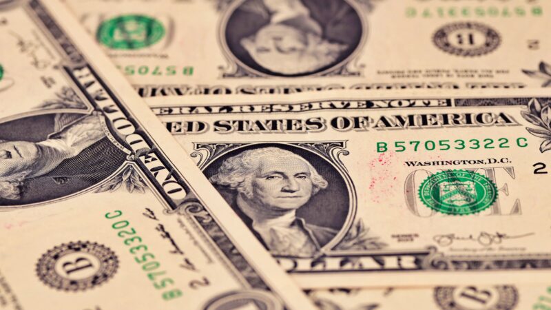 US dollar bills showing USD surge amid Fed rate hike, Foreign Treasury Holdings decline and Treasury sell off