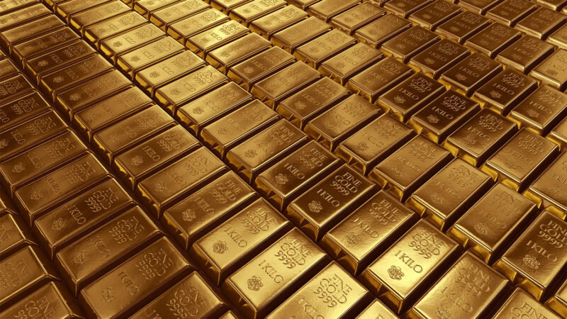 Gold bars representing gold price trends, Harry Dent gold prediction, Russia gold reserves, potential gold rally, and the future gold outlook.