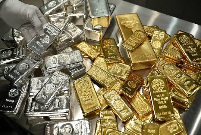 Gold and silver prices showing gold bars and silver bullion amid a gold price crash, silver price drop, gold market outlook, and concerns about why gold prices are falling.